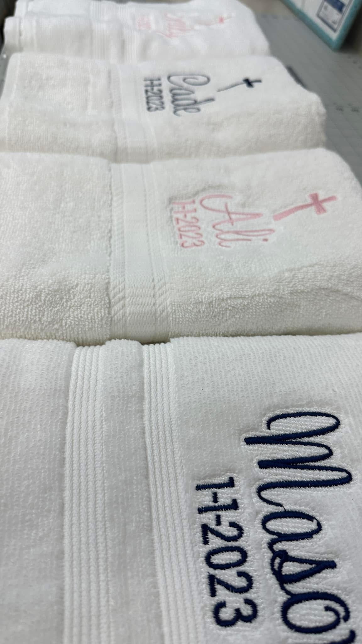 White towels with personalized embroidery for someone's baptism (Example: A cross, Ali, and baptism date)