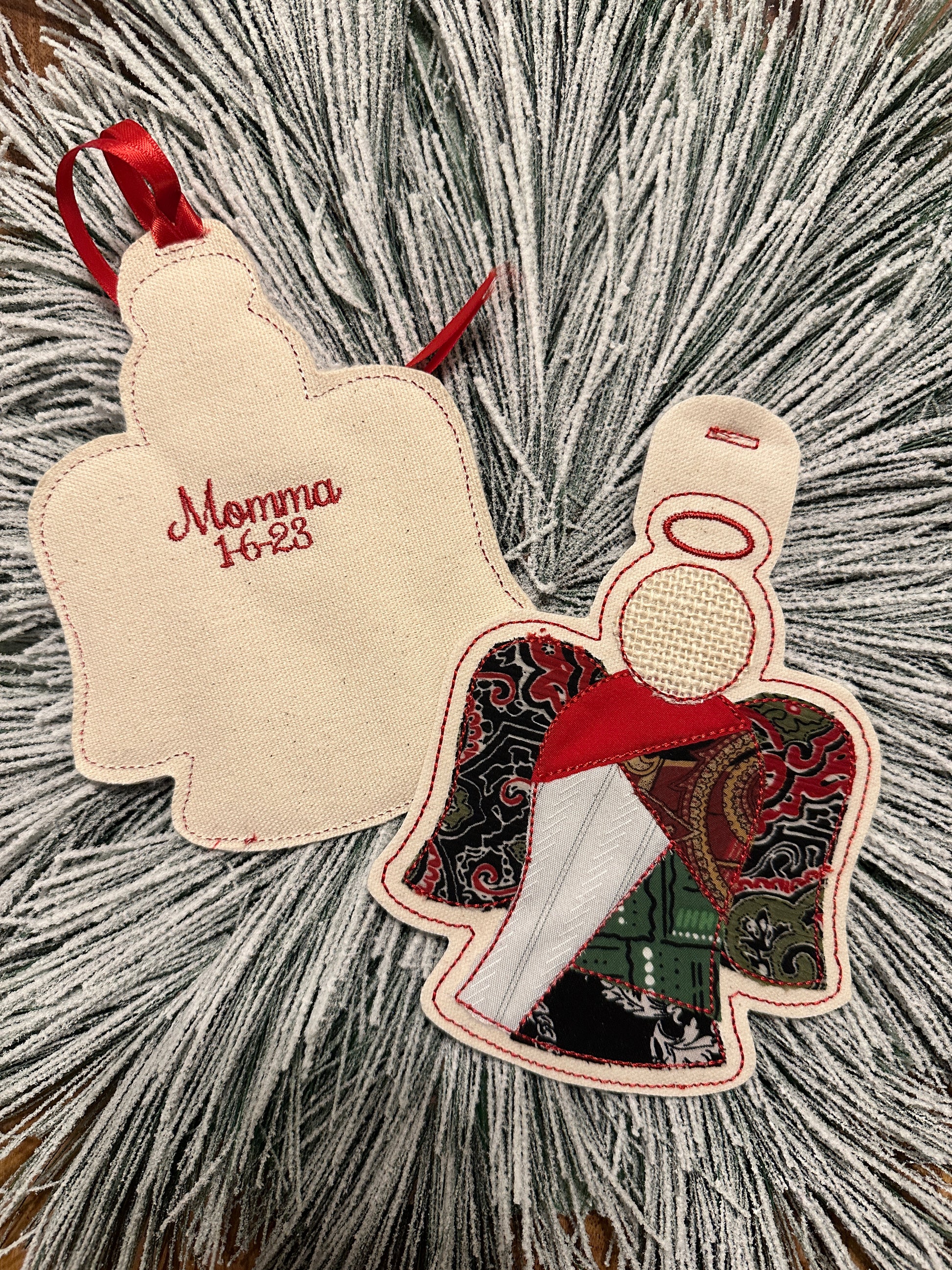Angel-shaped ornament with six articles of clothing from a loved one and embroidered loved one's name and death date