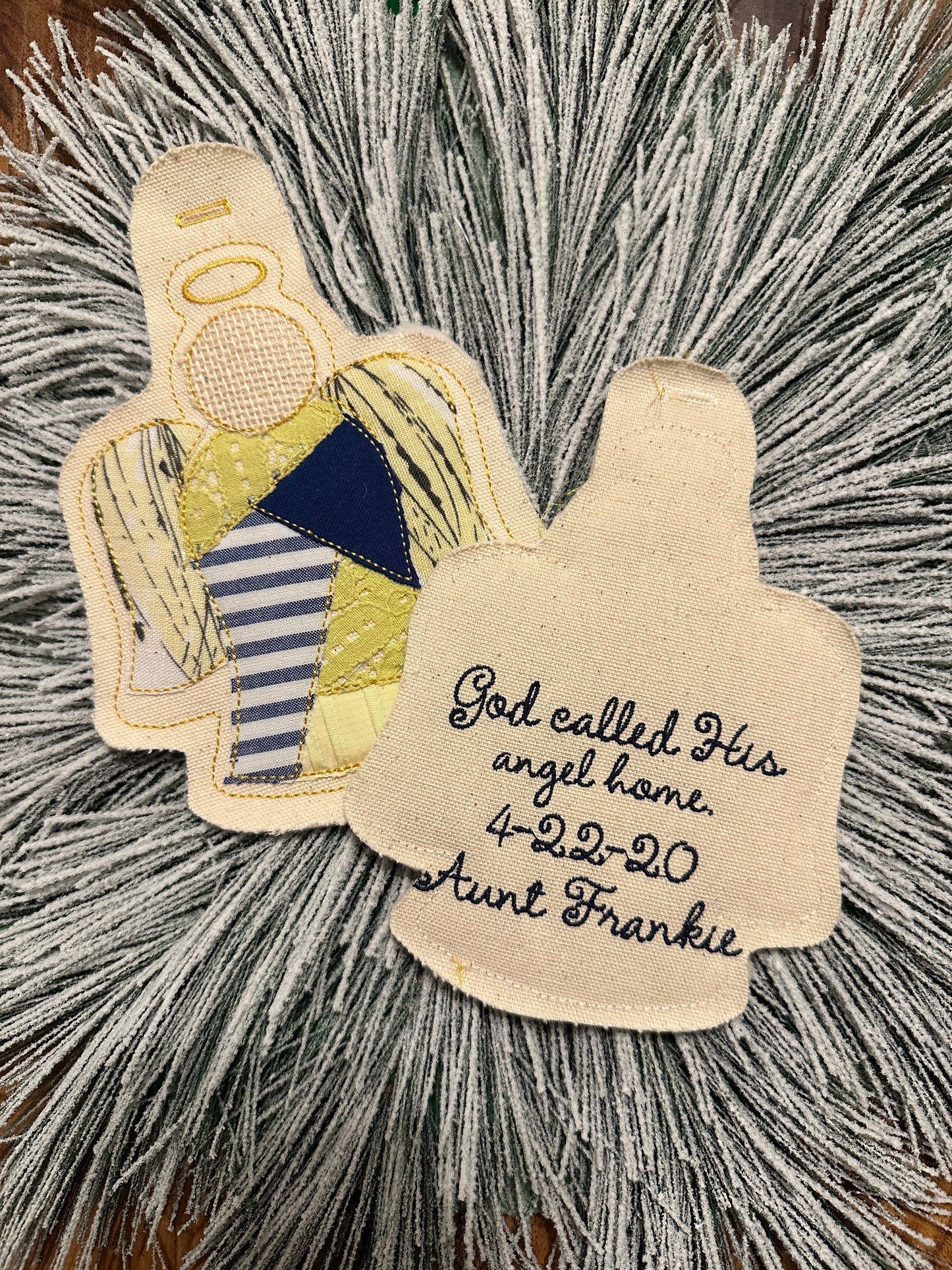 Angel-shaped ornament with six articles of clothing from a loved one and embroidered quote, death date, and love one's name