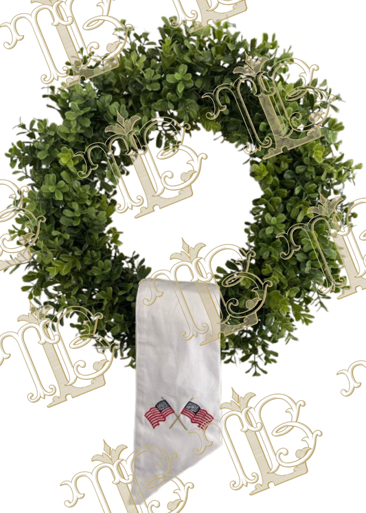 White sash with embroidered American flags in a criss-cross shape